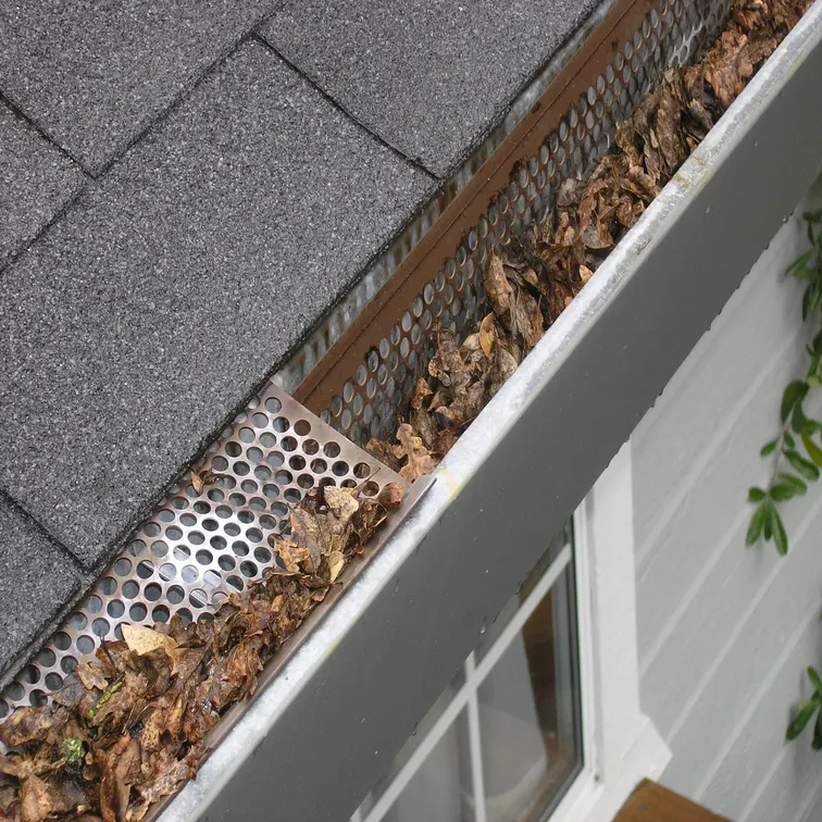 stainless steel gutter guard installation on home in Edmonton Alberta